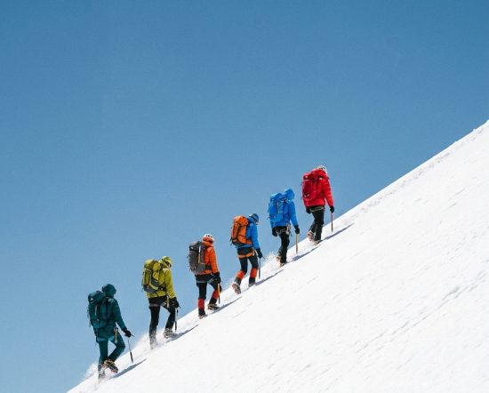 1790230859821-Teamwork-5-Climbers-on-Snow-Slope